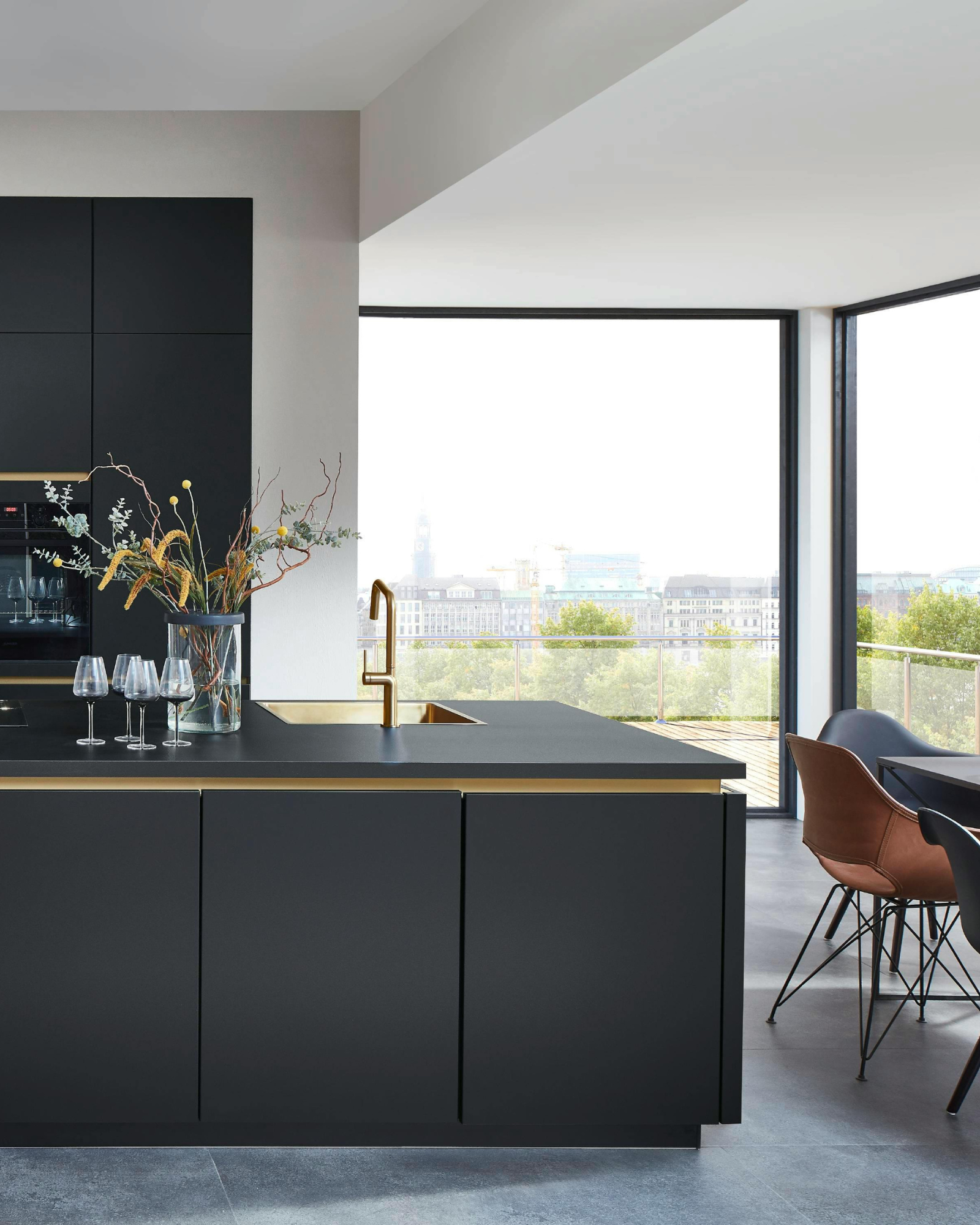 Interior design &mdash; finished kitchen with dark cabinetry and brass fixtures
